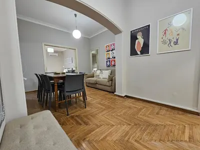 a dining room and living room with a table and chairs at Athens Vibes Apartment by YHA in Athens