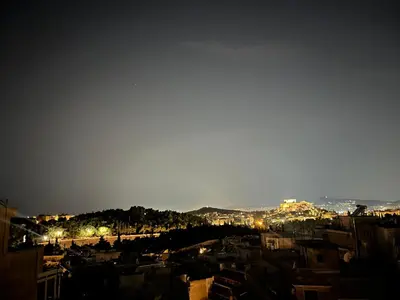 a view of a city at night at Loft Pagrati in Athens