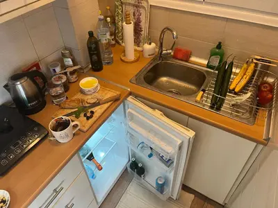 a small kitchen with a sink and a small refrigerator at Loft Pagrati in Athens