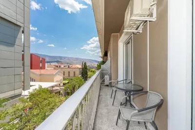 a balcony with two chairs and a table with a view at Kolonaki Elegant Apartment with Balcony in Athens