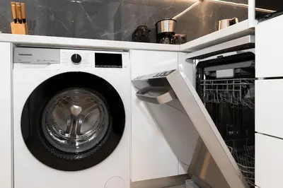 a washer and dryer in a white laundry room at Kolonaki Elegant Apartment with Balcony in Athens