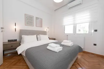 a bedroom with a large bed with towels on it at Kolonaki Elegant Apartment with Balcony in Athens