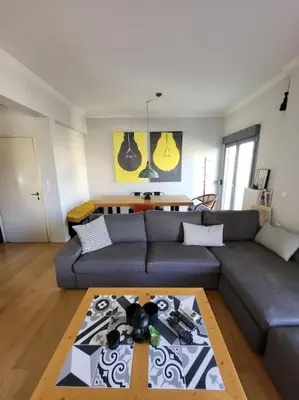 a living room with a couch and a table at Painters apartment in Athens