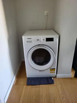 a washing machine in a corner of a room at Painters apartment in Athens