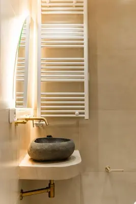 a bathroom with a stone sink and a window at Luxury 4Bdrm Penthouse near Acropolis in Athens