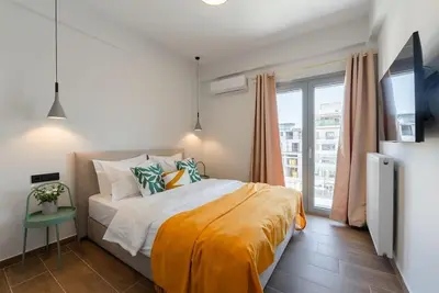 a bedroom with a bed and a large window at Luxury 4Bdrm Penthouse near Acropolis in Athens