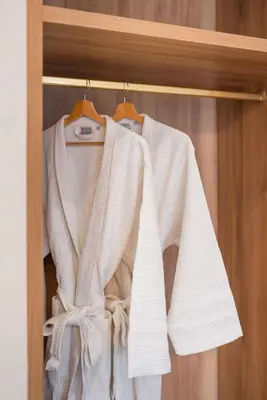 a white shirt is hanging on a rack at Luxury 4Bdrm Penthouse near Acropolis in Athens
