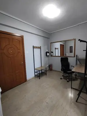 a room with a wooden door and a desk and chairs at Quiet and cozy apartment next to Acropolis in Athens