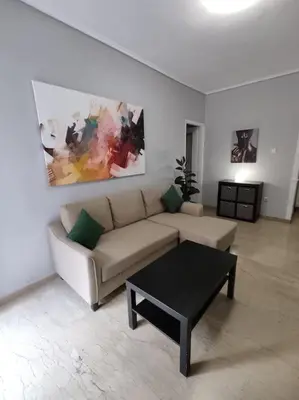 a living room with a couch and a coffee table at Quiet and cozy apartment next to Acropolis in Athens