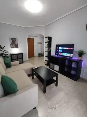 a living room with a couch and a coffee table at Quiet and cozy apartment next to Acropolis in Athens