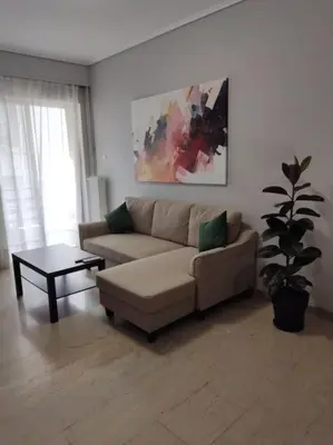 a living room with a couch and a table at Quiet and cozy apartment next to Acropolis in Athens