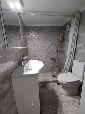 a bathroom with a toilet and a sink and a shower at Quiet and cozy apartment next to Acropolis in Athens