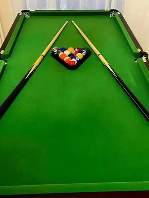 two cue sticks sitting on top of a pool table at Luxury 2BR Ellinikon Apartment Oasis - Athens Riviera in Athens