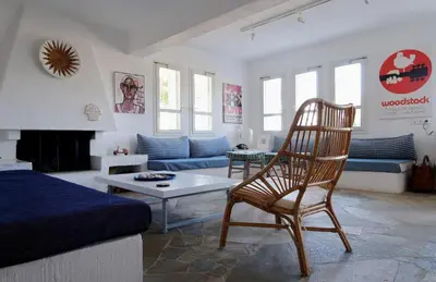 a living room with a chair and a couch at Hippie Bay Complex in Porto Rafti