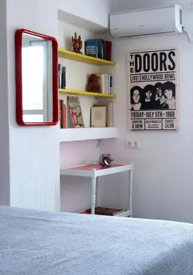 a bedroom with a bed and a mirror and shelves at Hippie Bay Complex in Porto Rafti