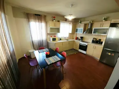 a small kitchen with a table and chairs in it at Nefeli Villa lagonisi - Pool in Lagonissi