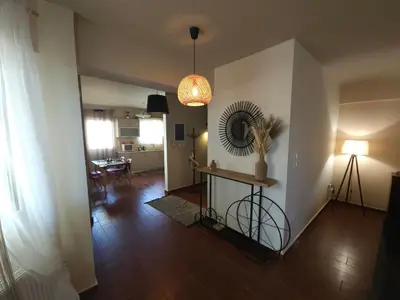 a living room with a table and a mirror on the wall at Nefeli Villa lagonisi - Pool in Lagonissi