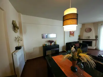 a living room with a table and a dining room at Nefeli Villa lagonisi - Pool in Lagonissi