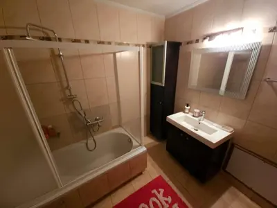 a bathroom with a tub shower and a sink at Nefeli Villa lagonisi - Pool in Lagonissi