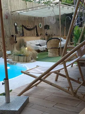 a patio with a chair and a swimming pool at Nefeli Villa lagonisi - Pool in Lagonissi