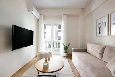 a living room with a couch and a table at Athens Heart Stay 1BR Apartment in Koukaki by UPSTREET in Athens