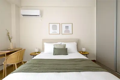 a bedroom with a large bed and a desk at Athens Heart Stay 1BR Apartment in Koukaki by UPSTREET in Athens
