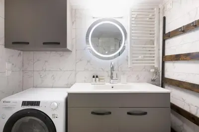 a bathroom with a washing machine and a sink at Athens Heart Stay 1BR Apartment in Koukaki by UPSTREET in Athens
