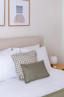 a bed with white sheets and a pillow on it at Athens Heart Stay 1BR Apartment in Koukaki by UPSTREET in Athens