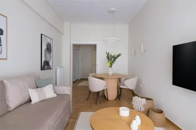 a living room with a couch and a table at Athens Heart Stay 1BR Apartment in Koukaki by UPSTREET in Athens