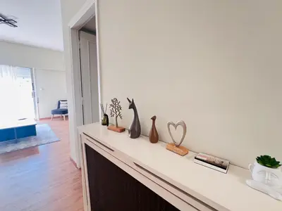 a living room with a fireplace with vases on it at Concert Hall Apartment - Semitelou in Athens