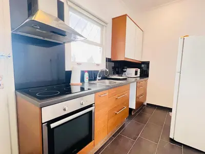 a kitchen with a sink and a stove top oven at Concert Hall Apartment - Semitelou in Athens