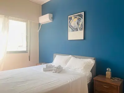 a blue bedroom with a bed with two stuffed animals on it at Concert Hall Apartment - Semitelou in Athens