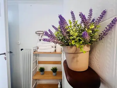 a large vase with purple flowers on a wall at Concert Hall Apartment - Semitelou in Athens