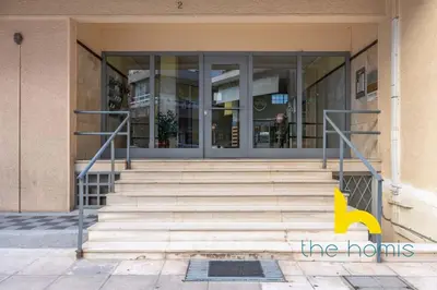 a building with stairs in front of a building at Upscale central APT, Patio near Hospitals & Metro in Athens