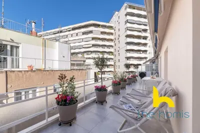 a balcony with a chair and potted plants on a building at Upscale central APT, Patio near Hospitals & Metro in Athens
