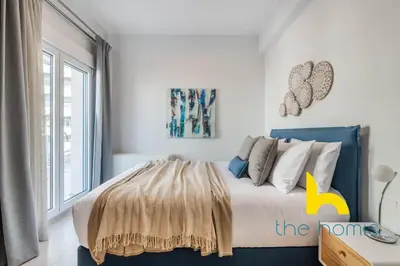 a bedroom with a bed with a yellow letter k on it at Upscale central APT, Patio near Hospitals & Metro in Athens