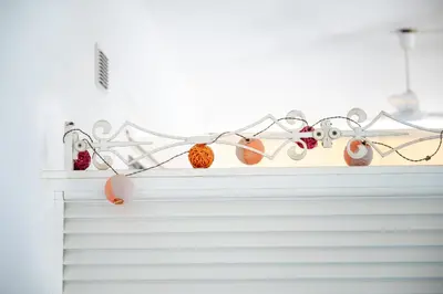 a shelf with christmas ornaments on top of a fireplace at Sun & Sea Escape Charming Vacation Apartment in Voula on Athen's Riviera in Athens