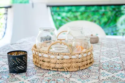 a basket of glass jars on a table at Sun & Sea Escape Charming Vacation Apartment in Voula on Athen's Riviera in Athens