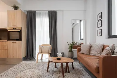 a living room with a couch and a table at Orpheas Athens Comfy Apartment in Athens