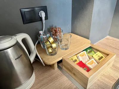 a small table with a coffee maker and a table with a table sidx sidx sidx at Orpheas Athens Comfy Apartment in Athens