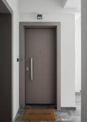 a door with a welcome mat in front of it at Orpheas Athens Comfy Apartment in Athens