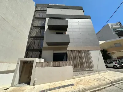 a tall building with a door in front of it at Orpheas Athens Comfy Apartment in Athens