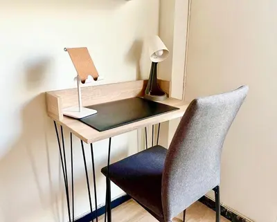 a desk with a chair and a lamp on it at Cosy studio in Pagrati Caravel, 4th floor in Athens