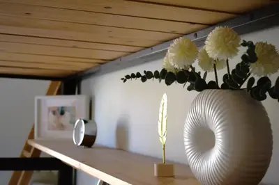 a vase with flowers in it on a table at Cosy studio in Pagrati Caravel, 4th floor in Athens