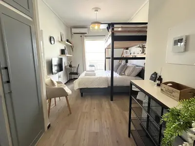 a bedroom with a bunk bed and a desk at Cosy studio in Pagrati Caravel, 4th floor in Athens