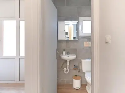 a bathroom with a toilet and a sink at Cozy Garden Studio in Athens