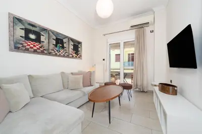 a living room with a couch and a table at Modern Apartment in Athens Center, 10 mins walk to Plaka Historical Area in Athens