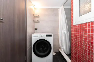 a small bathroom with a washing machine in it at Modern Apartment in Athens Center, 10 mins walk to Plaka Historical Area in Athens