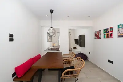 a dining room with a wooden table and chairs at Modern Apartment in Athens Center, 10 mins walk to Plaka Historical Area in Athens
