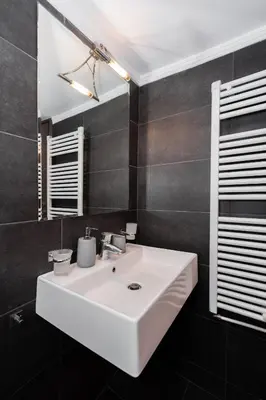 a bathroom with a white sink and a mirror at Modern Apartment in Athens Center, 10 mins walk to Plaka Historical Area in Athens